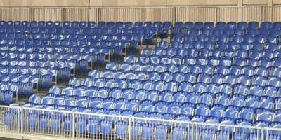Demountable metal grandstands with blue seats at Dubai International Badminton World Cup, modular sports event seating