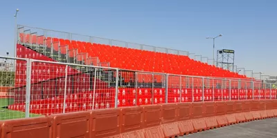Demountable metal grandstands with red seating at Ferrari Launch Riyadh event, temporary outdoor venue seating