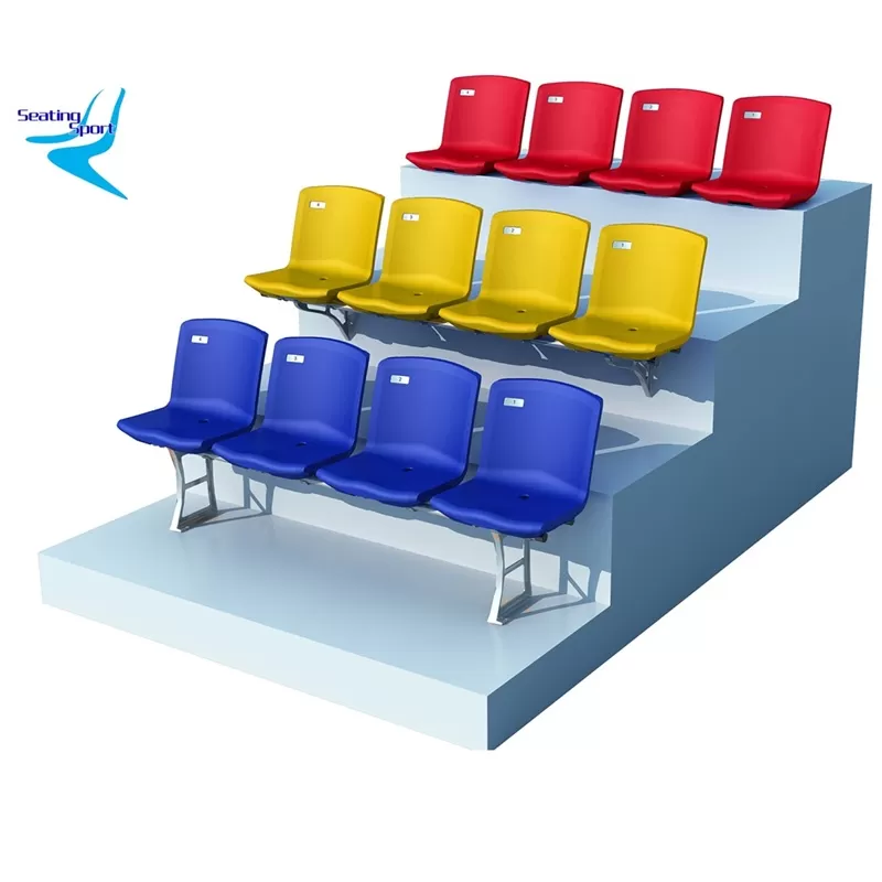 Colorful tiered sports venue seating — Red, yellow, and blue plastic stadium seats for arenas