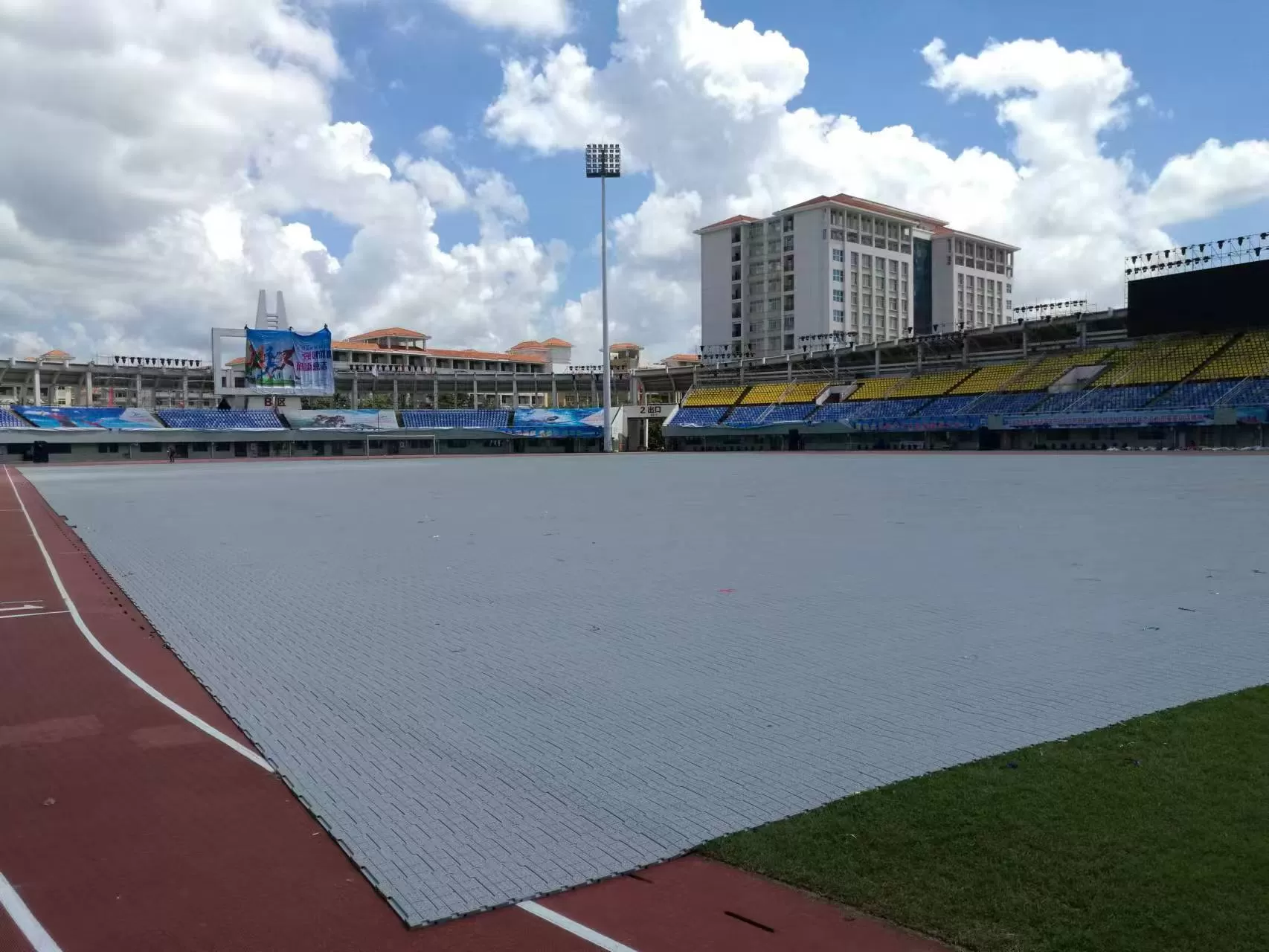 Turf protection mat and temporary event ground cover installed on a stadium field for event use